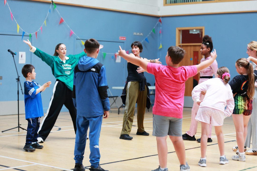 Justine Doswell dances with young people at a Community Celebration in Bluebell Dublin 12