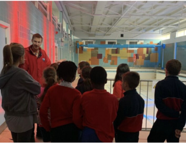 A Visitor Experience Assisitant at Dublin City Council Culture Company welcomes people to an exhibition