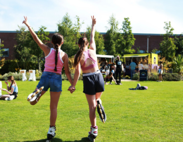 2 girls stand balancing together in the gardens of Richmond Barraks Inchicore Dublin 8