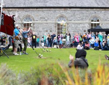 An outdoor concert at Richmond Barracks Inchicore Dublin 8 where people are being encouraged to clap along