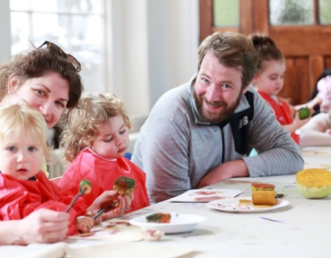 A family of two adults and two children attend a Culture Connects workshop at Richmond Barracks