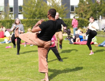 People dance outside at a Culture Connects workshop in the Richmond Barracks garden