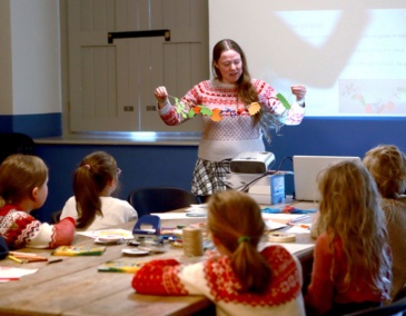 Education children participating in a creative workshop in 14 Henrietta Street watch and listen to Dervilia Historian in Residence for Children 800 x 540
