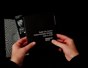 Decorative: A pair of hands hold the printed version of the Dublin City Council Culture Company Strategy 2025 to 2030 -- 800 x 540