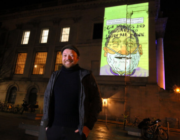 Artist Alan Dunne with his illustrations on City Hall. Credit: Mark Stedman.