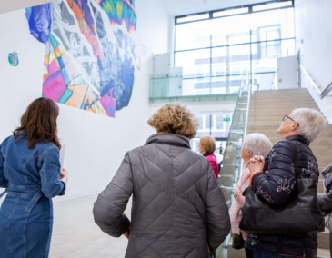 Group of people looking up at an artwork in the RHA Gallery