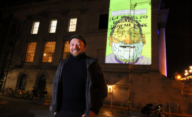 Artist Alan Dunne with his illustrations on City Hall. Credit: Mark Stedman.
