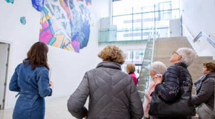 Group of people looking up at an artwork in the RHA Gallery