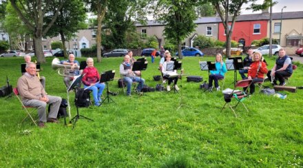 John (third from the left, with tuba) at band rehearsal in the park