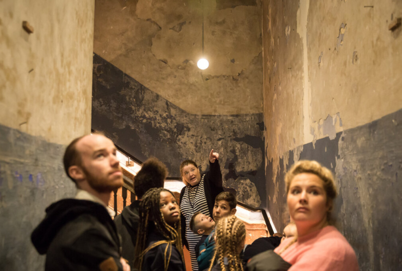 Tour Guide points at architectural feature in 14 Henrietta Street