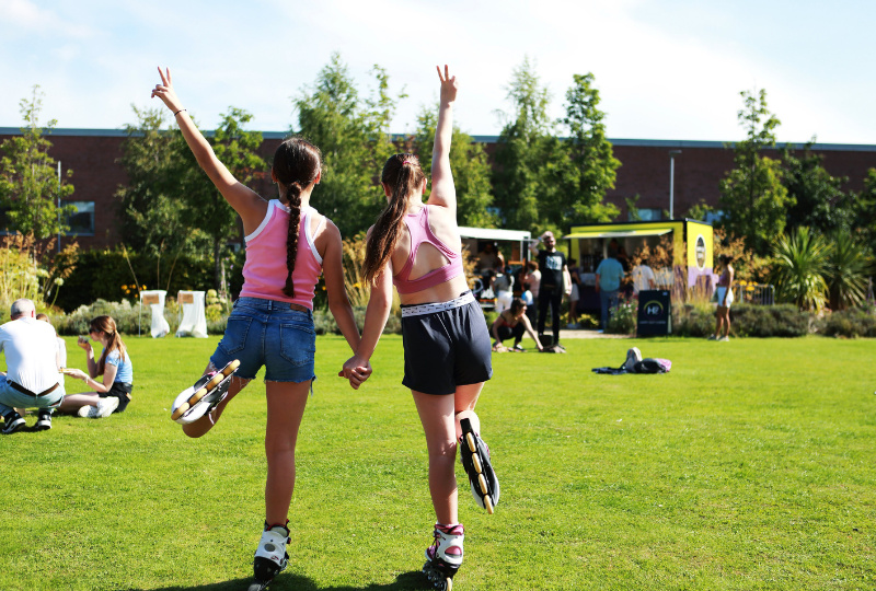 2 girls stand balancing together in the gardens of Richmond Barraks Inchicore Dublin 8