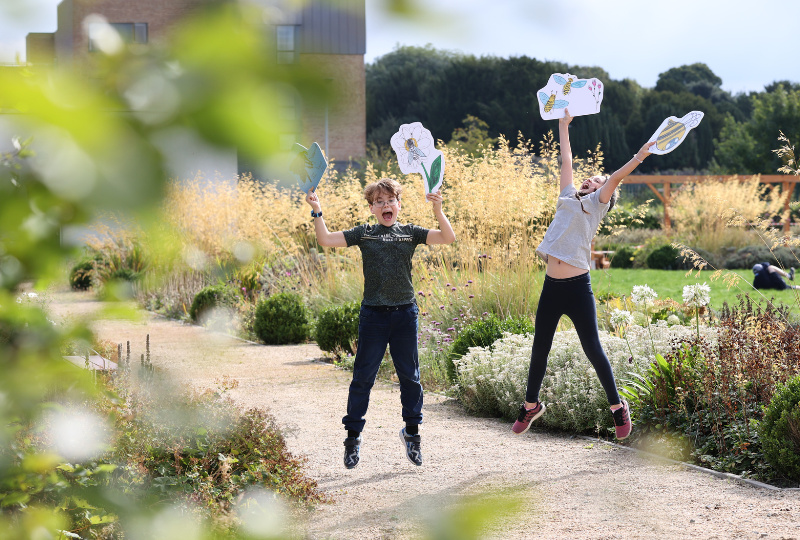 Children holding illustrated signs play in the garden of Richmond Barracks Inchicore Dublin 8