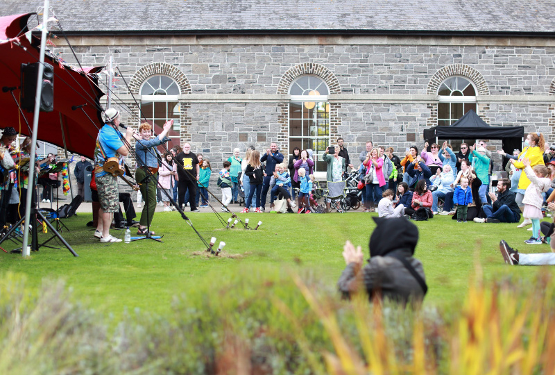 An outdoor concert at Richmond Barracks Inchicore Dublin 8 where people are being encouraged to clap along