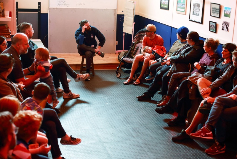 DCCCC website news stories 800 x 540 a group of people in a room listening to someone speaking