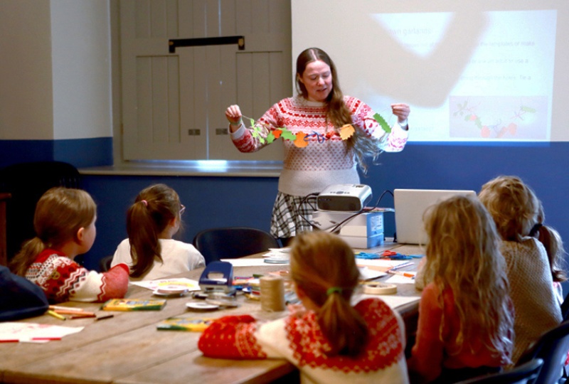 Education children participating in a creative workshop in 14 Henrietta Street watch and listen to Dervilia Historian in Residence for Children 800 x 540