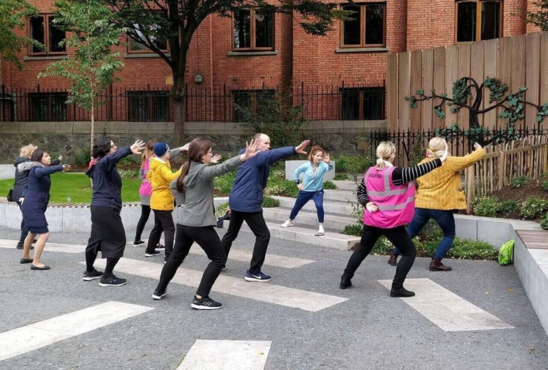 Aideen leading an outdoor yoga class