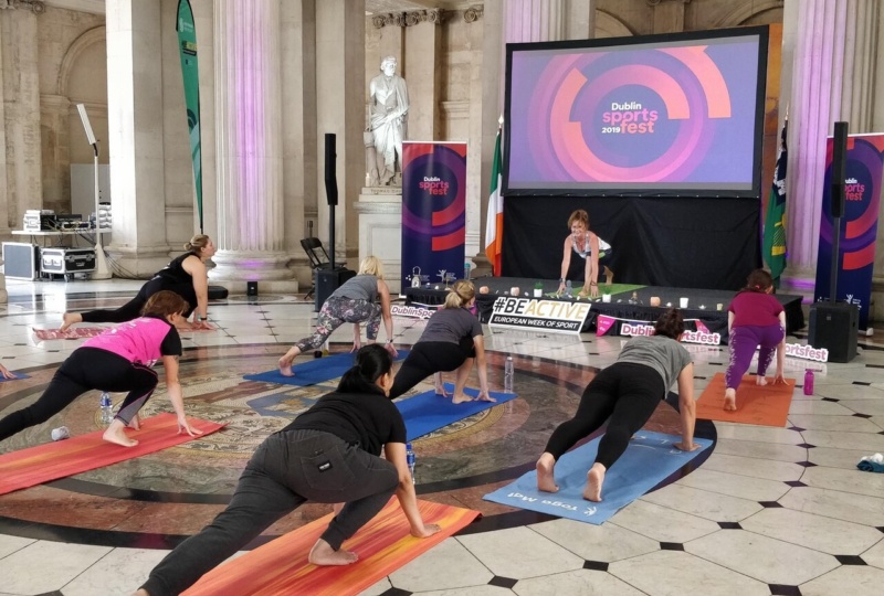 Aideen teaching a yoga class in City Hall for Sportsfest 2019