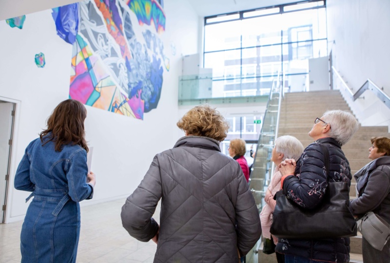 Group of people looking up at an artwork in the RHA Gallery